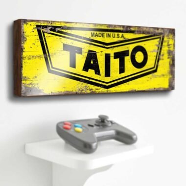 Taito Retro Game Sign. This sign brings the iconic logo of one of the most influential arcade game companies to life. Perfect for any gaming enthusiast, this piece adds a nostalgic touch to any room.